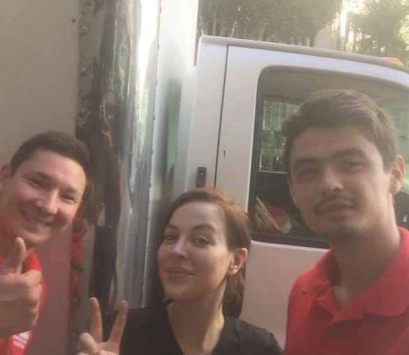 Movers next to a happy customer